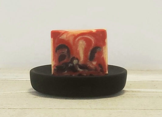 A red and cream swirl colored handmade soap